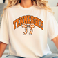 A person wearing a white t-shirt with the word "TENNESSEE" and a checkered bow printed on it.