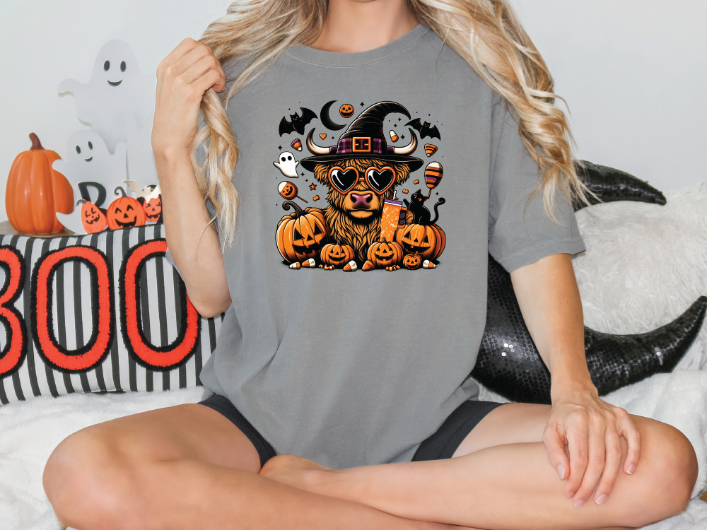 a woman sitting on a bed wearing a halloween shirt