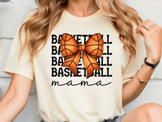 A woman wearing a white t-shirt with a basketball graphic and the word "mama" written below it.