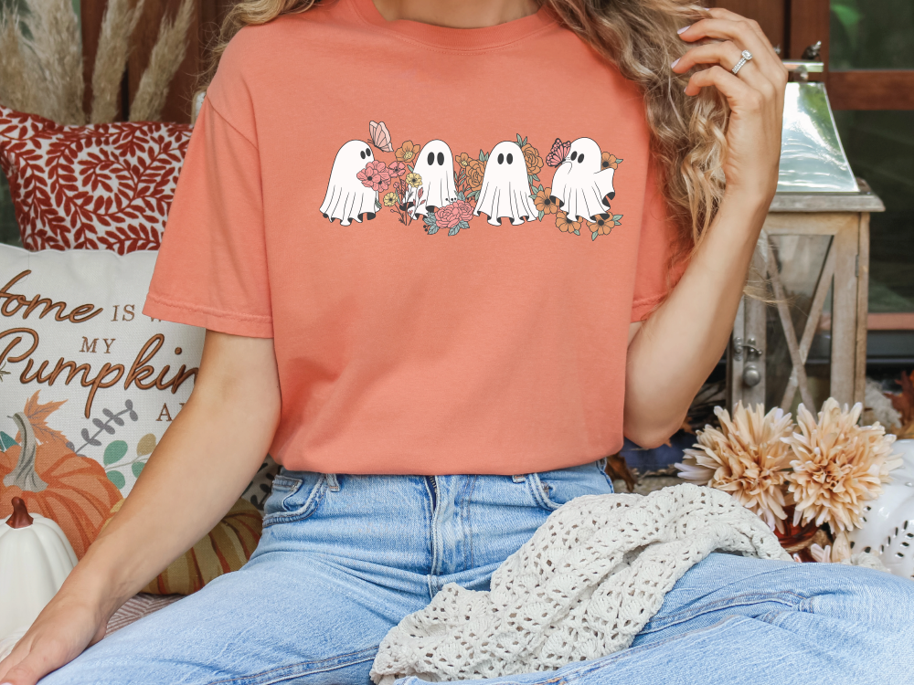 a woman sitting on a couch wearing a ghost t - shirt