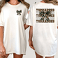A woman wearing a white t-shirt with a graphic design on the back.