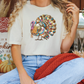 a woman sitting on a couch with a turkey t - shirt on