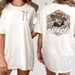 two different views of a white t-shirt with a graphic design on the back. The design features a cartoon character wearing a cowboy hat and the word "Patriots" written below it.