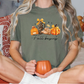 a woman sitting on a bed holding a pumpkin