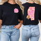 two women wearing black shirts with pink and yellow designs