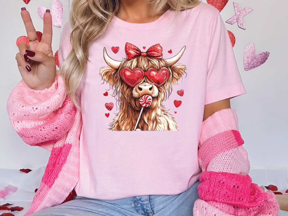 a woman wearing a pink shirt with a cow on it