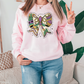 a woman wearing a pink sweatshirt with a butterfly on it