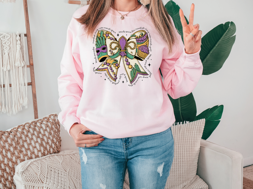 a woman wearing a pink sweatshirt with a butterfly on it