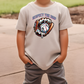 a young boy wearing a t - shirt with a baseball glove on it