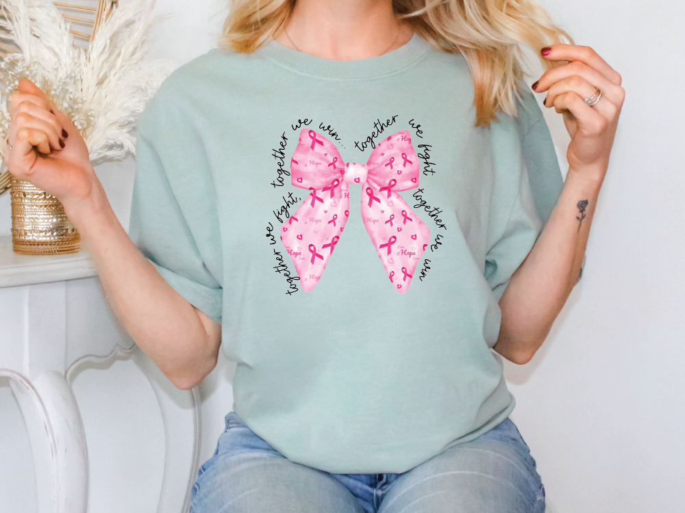 a woman sitting on a chair with a pink bow on her shirt