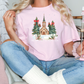 a woman sitting on a couch holding a pink t - shirt