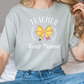 a woman sitting on a bed wearing a t - shirt that says teacher your name