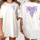 two women wearing white t-shirts with colorful, abstract designs on the back.