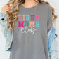 a woman wearing a grey shirt that says tired moms club