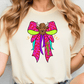 A woman wearing a white t-shirt with a colorful graphic design of a bull's head on a bow.