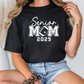 a woman wearing a black shirt that says senior mom