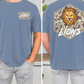 a man wearing a blue t-shirt with a lion graphic and the word "LIONS" printed on it.