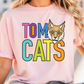 A person wearing a pink t-shirt with the text "TOM CATS" and an illustration of a cat's face.