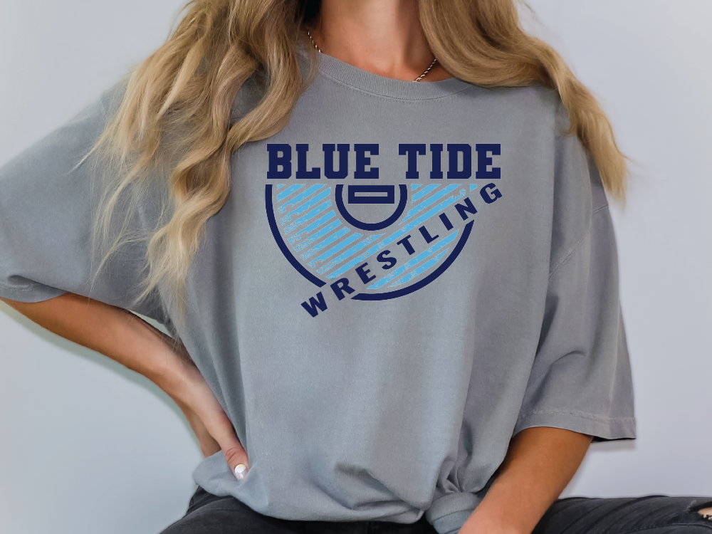 a woman wearing a blue tide wrestling t - shirt