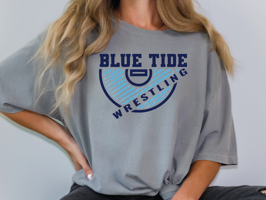 a woman wearing a blue tide wrestling t - shirt