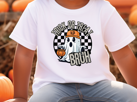 a young boy wearing a trick or treat t - shirt