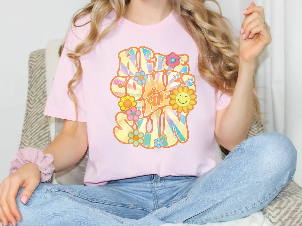 a woman sitting on a couch wearing a pink shirt