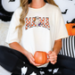 a woman sitting on a bed holding a pumpkin