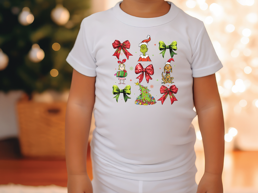 a little girl wearing a white shirt with christmas decorations on it