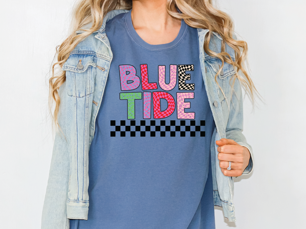 a woman wearing a blue t - shirt that says blue tide