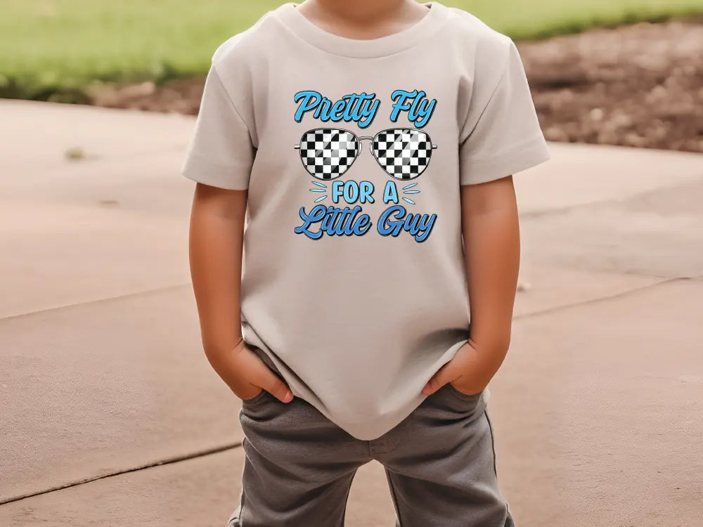 a young boy wearing a t - shirt with glasses on it