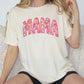 a woman sitting on a couch wearing a shirt that says mama