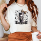 a woman holding a coffee cup and wearing a t - shirt