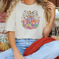 a woman sitting on a couch wearing a t - shirt with a bow on it