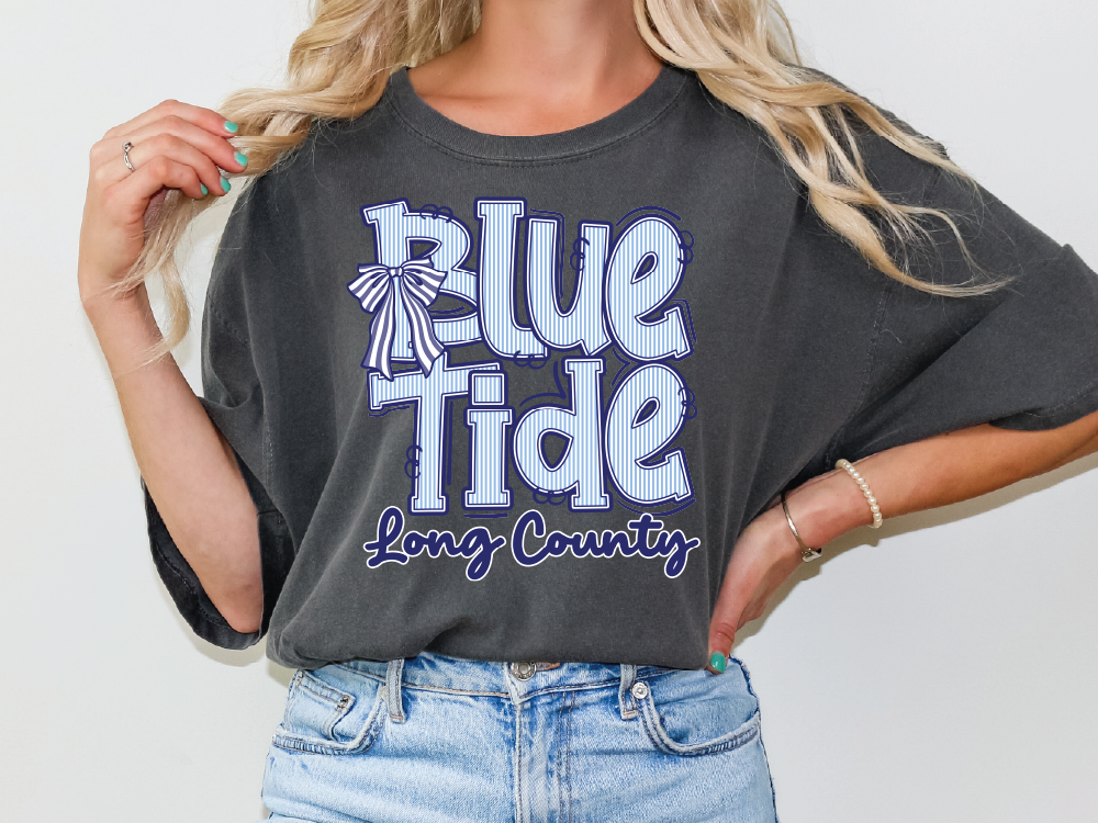 A woman wearing a gray t-shirt with the text "Blue Tide Long County" printed on it.