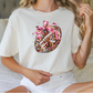 a woman sitting on a bed wearing a shirt with a football on it