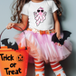 a little girl in a trick or treat costume holding a trick or treat bucket