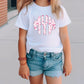 a little girl wearing a white shirt and shorts