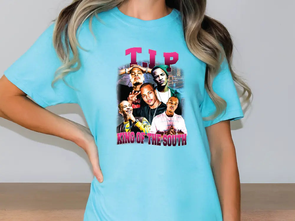 a woman wearing a blue t - shirt with a picture of a group of people