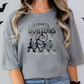 a woman wearing a grey t - shirt with a picture of two skeletons on it