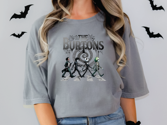 a woman wearing a grey t - shirt with a picture of two skeletons on it