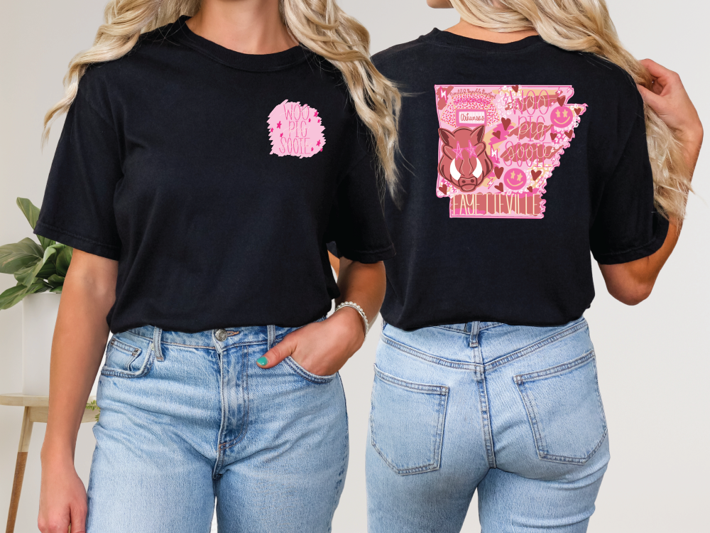 two women wearing black tshirts with pink designs on them