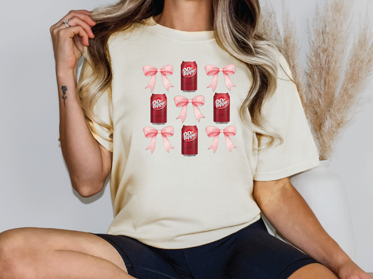 a woman sitting on a chair wearing a t - shirt with a bow on it