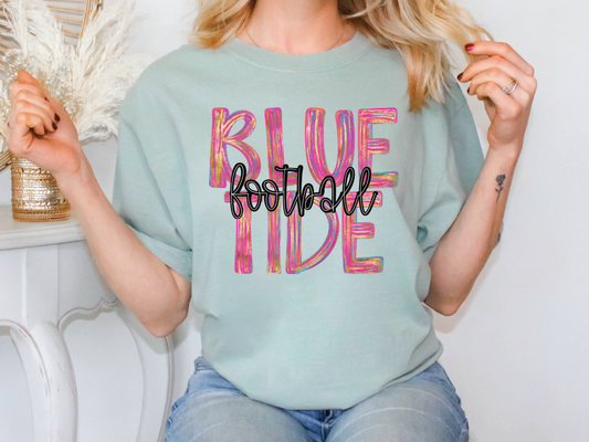 a woman wearing a blue shirt with the words blue tide on it