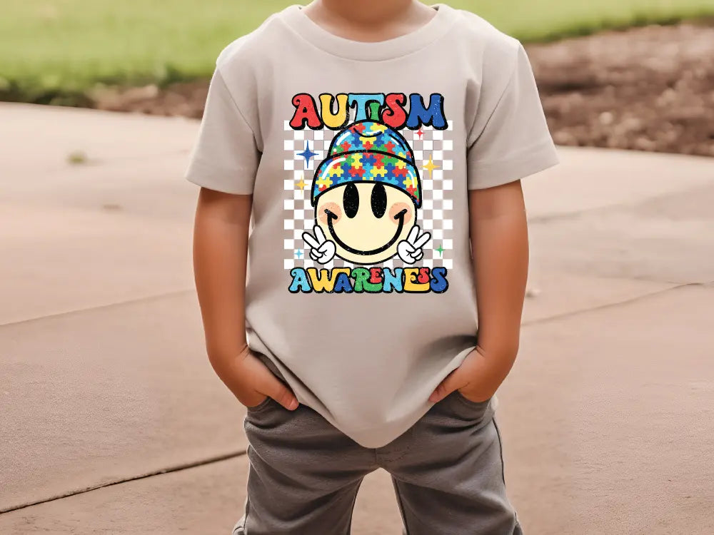 a young boy wearing a t - shirt that says autism awareness