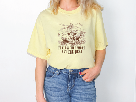 a woman wearing a yellow t - shirt that says follow the word not the head