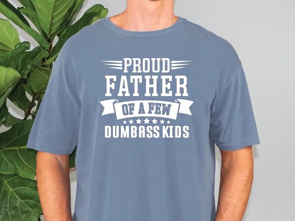 a man wearing a t - shirt that says proud father of a few dumbers