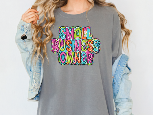 a woman wearing a gray shirt that says small business owner