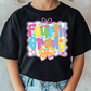 a young girl wearing a black tshirt with the words fourth grade on it