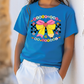 a little girl wearing a blue shirt with a bow