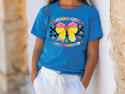 a little girl wearing a blue shirt with a bow